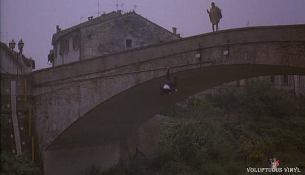 Monica Bellucci standing on a bridge