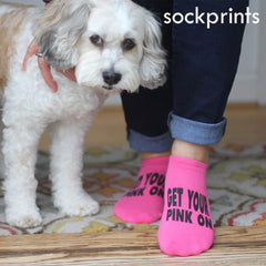 This is an image of customized "Get Your Pink On" no show fuchsia pink socks and a dog.