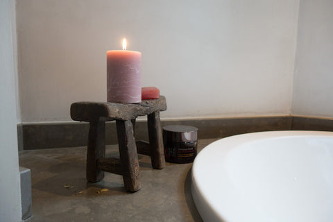 Mini antique wooden stool used as candle and soap holder