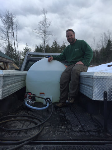 Derek sitting next to his full tank of sap!