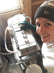 Corrie cleaning the filter press, which filters the maple syrup