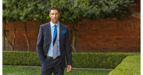 Man in blue suit with blue Lesovs silk tie and pocket square