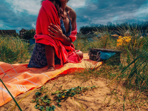 Girl on a beach with hammam wrap