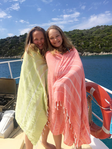 The girls wrapping up in Sorbet towels on deck