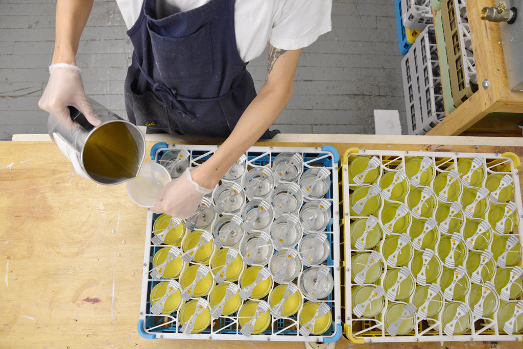 Keap hand pouring coconut wax candles at Industry City Brooklyn