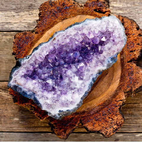 amethyst druzy geode on a wooden plate