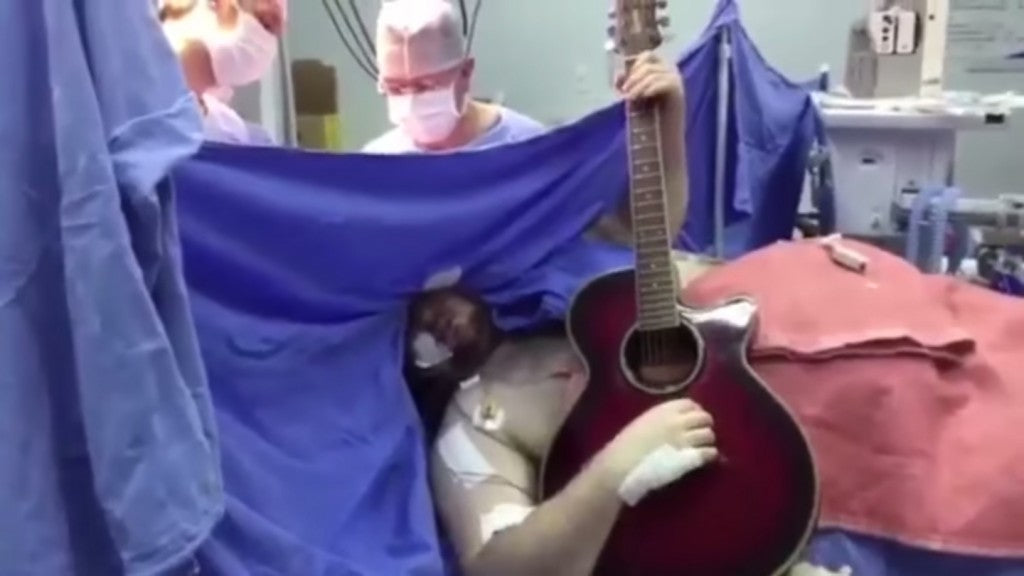Man plays guitar during brain tumor