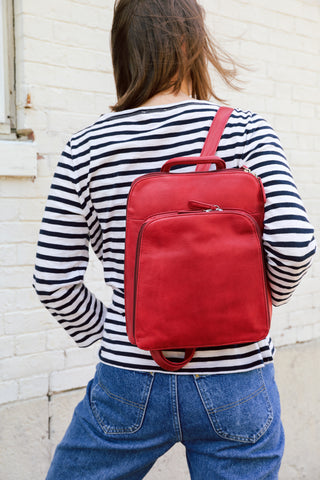model wearing small organizer backpack in garnet 