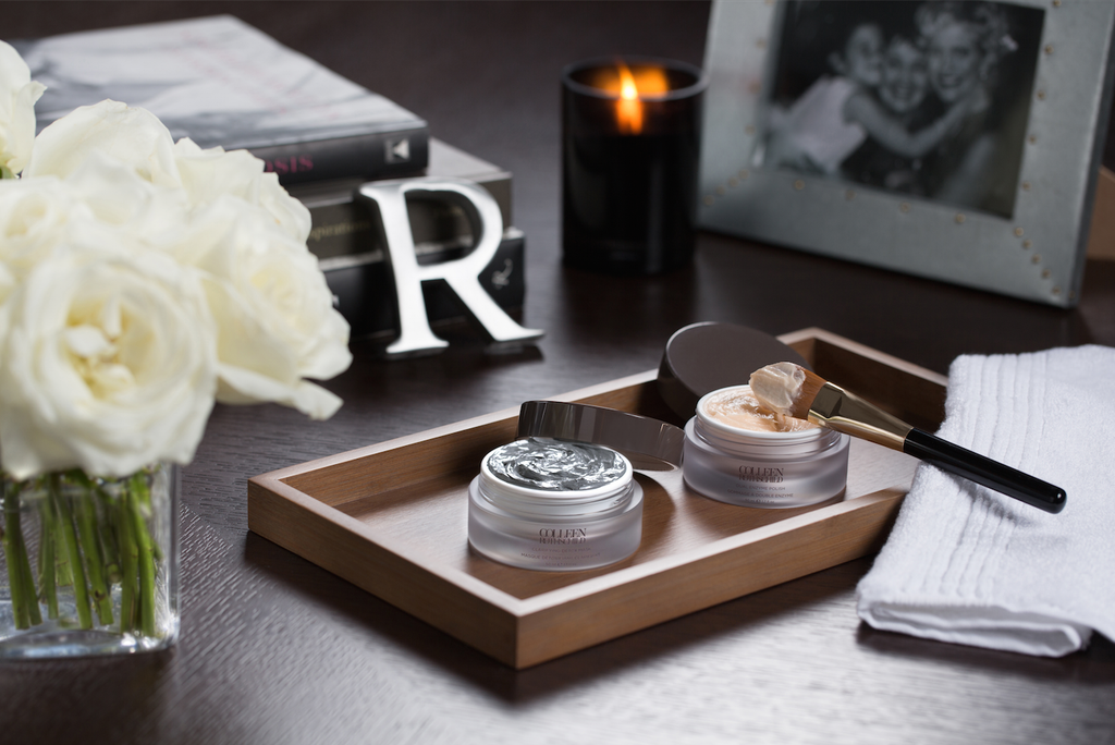 skincare products on desk with flowers