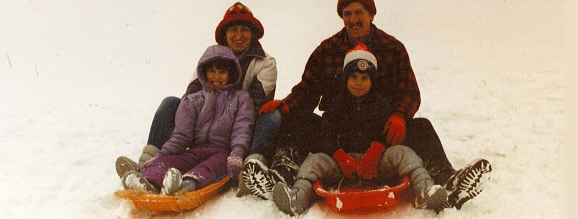 Young Ryan Smoker with his family on sleds