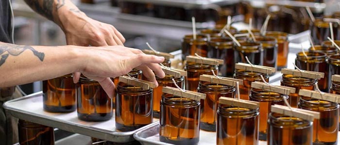 PF Candle wax being poured into jars