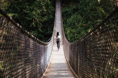 woman walks on bridge