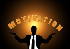 Silhouetted man with arms out wide with the word motivation over him.