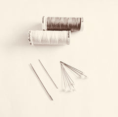 Red Rufus black and white image of thread and needles