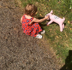 Little girl outside with her large Red Rufus SockDog