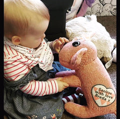 Baby with a pink Red Rufus SockDog