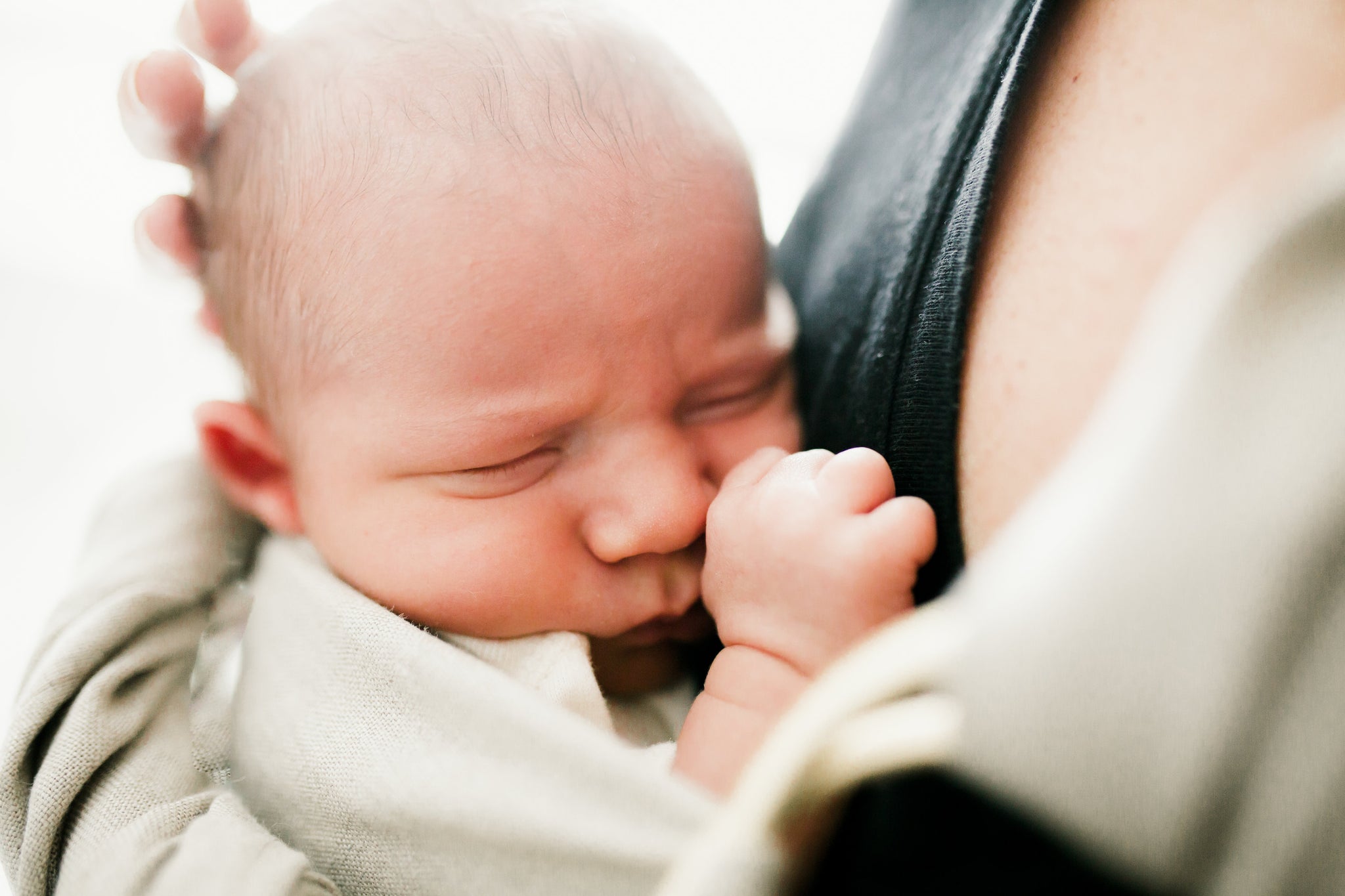 Newborn baby in luxury linen ring sling carrier