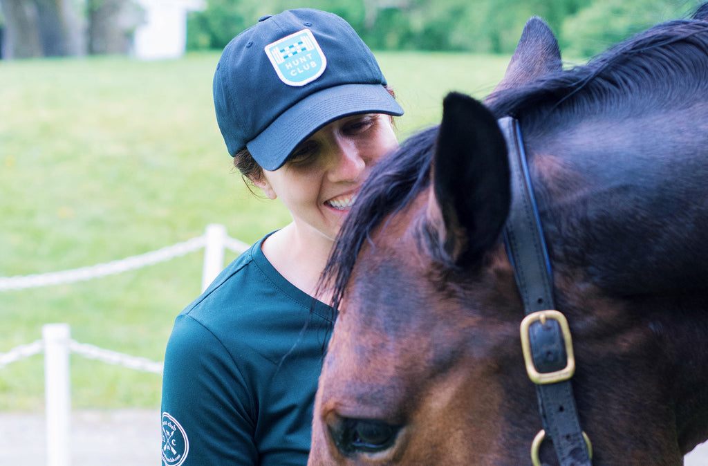 Female equestrian smiling with a horse