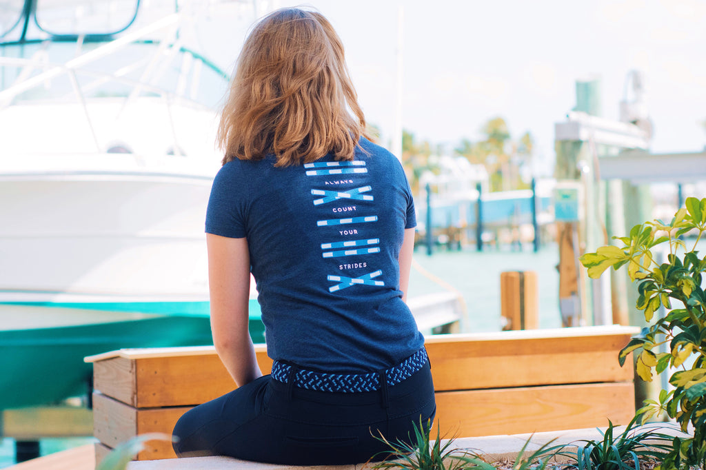 Equestrian rider wearing a navy blue tee. 