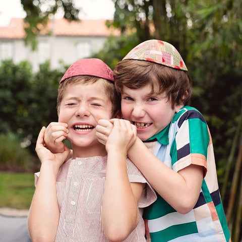 Two boys being silly while wearing iKIPPAHS.