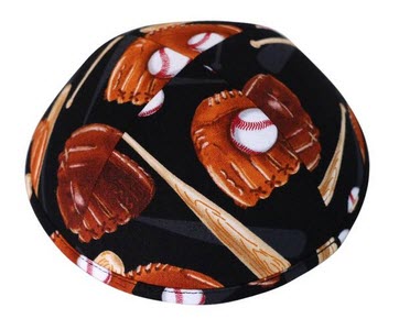 Vibrant brown baseball bats & gloves along with a white baseball with red stitches on a dark black fabric of a Kippah.