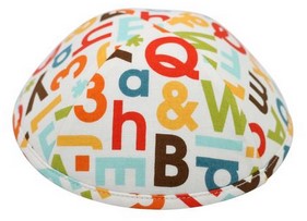 A unique iKIPPAH brand yarmulke called 'typography' with colorful letters & numbers in the pattern of the fabric.