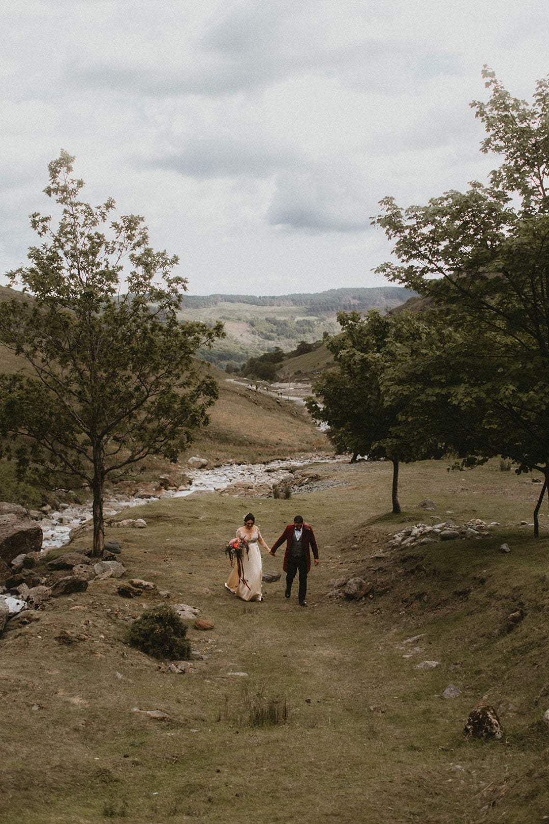 Bride and Groom walking in country landscape