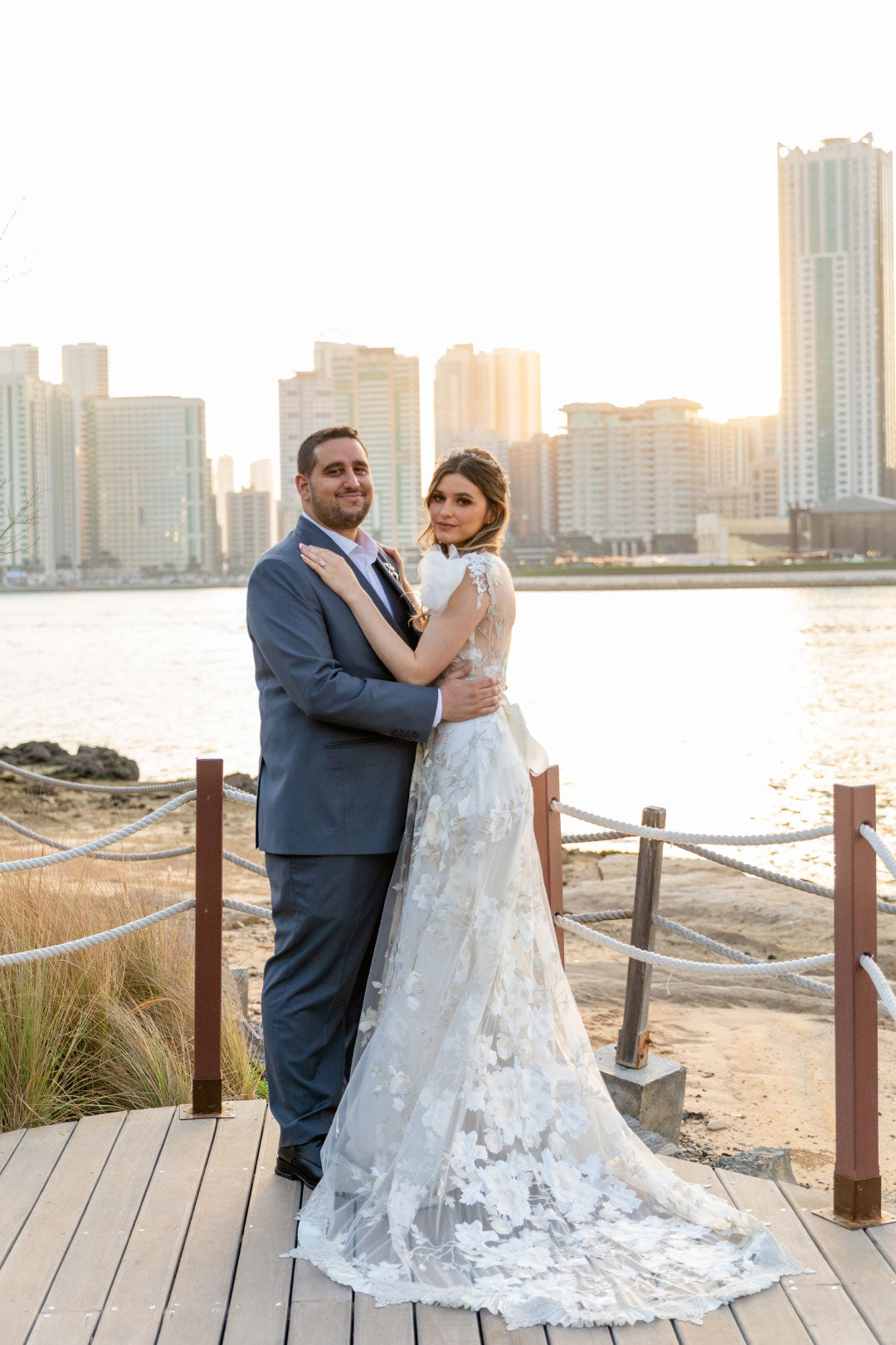 Bride and Groom in front of river city scape bridal portrait