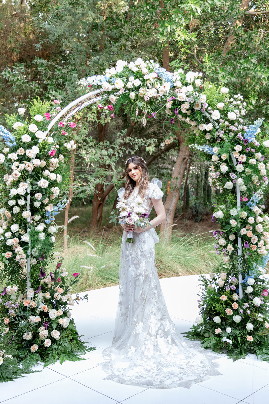 Bride under wedding floral display