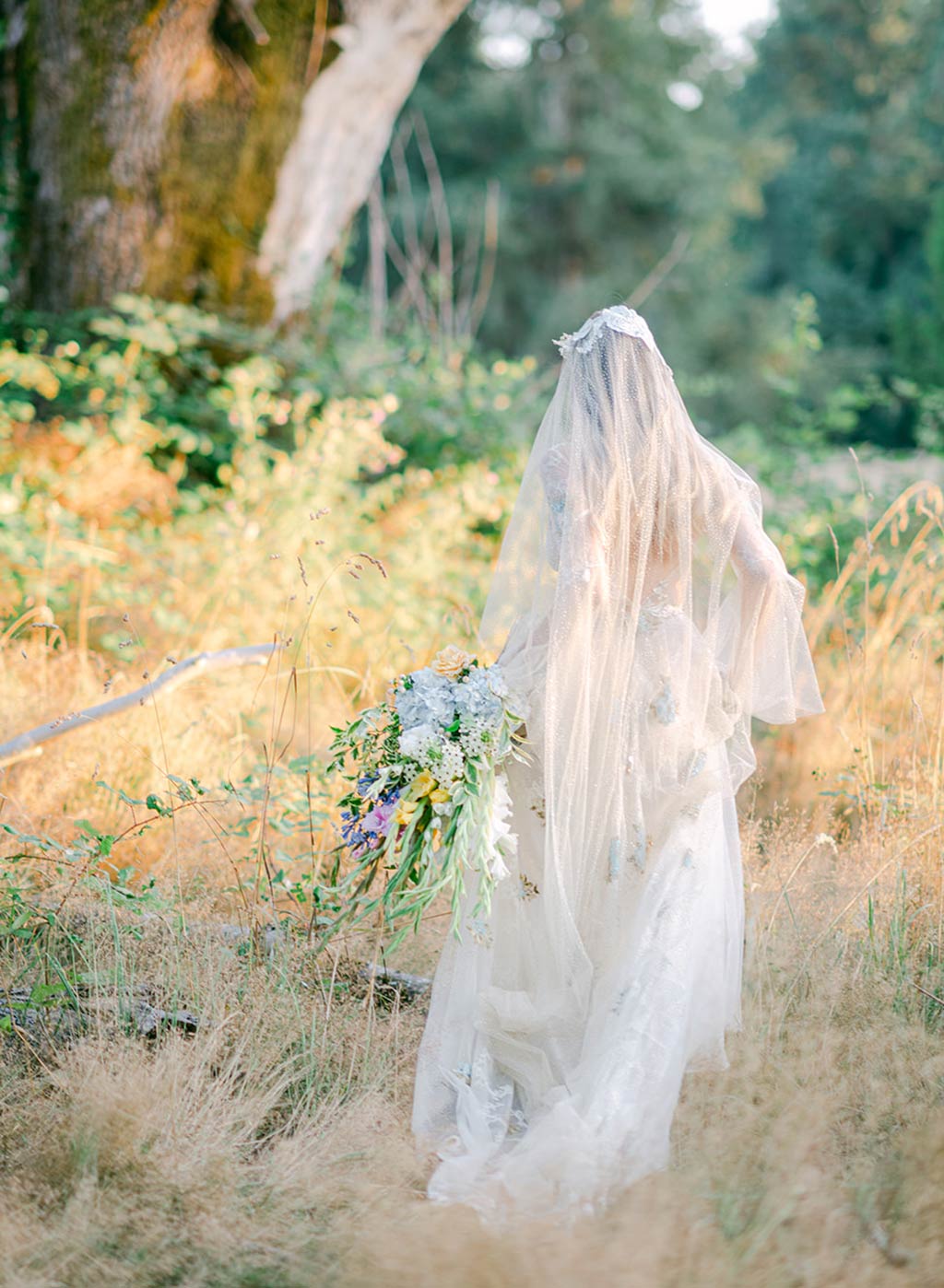 Bride in Wedding Dress and Veil in Garden Wedding Setting