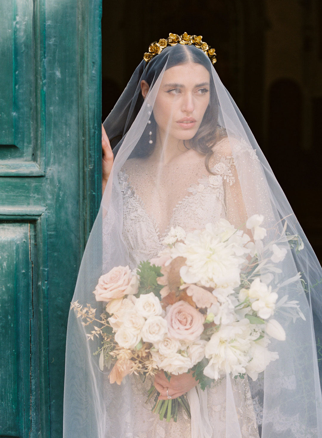 Bride in Wedding Veil holdng floral bouquet