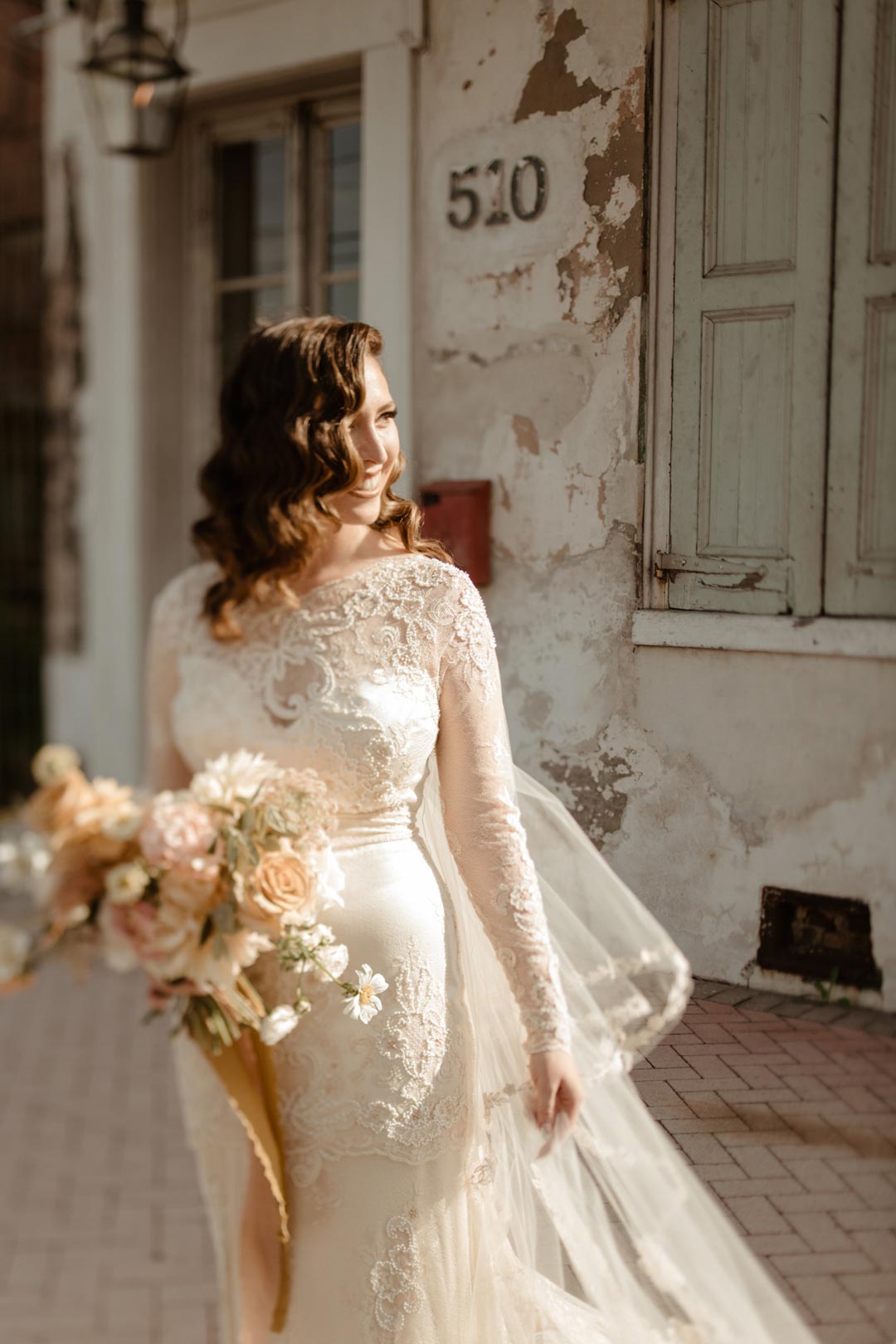 Bride holding floral bouquet Wedding Dress Design Claire Pettibone