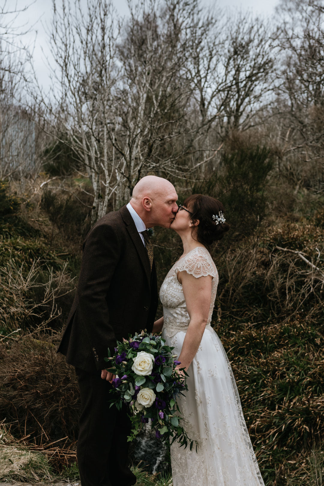 Bride and groom kissing for wedding photos