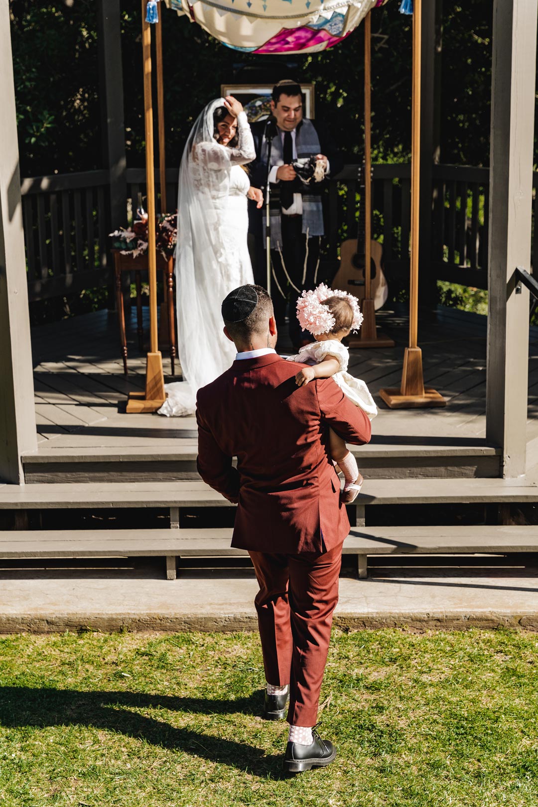 Bride walks with baby 