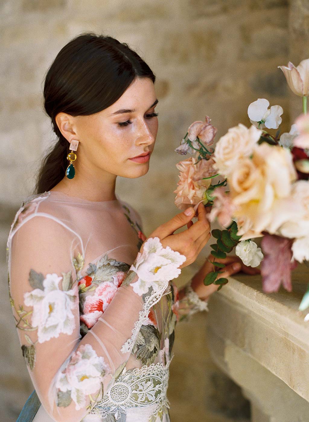 Bride with Wedding Floral Arrangement