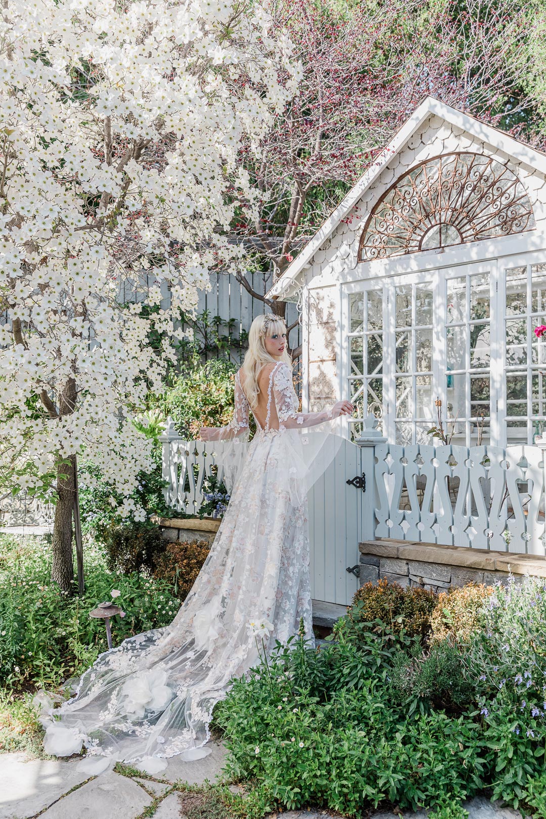 Floral Garden Wedding Venue with Model in Wedding Dress by Claire Pettibone