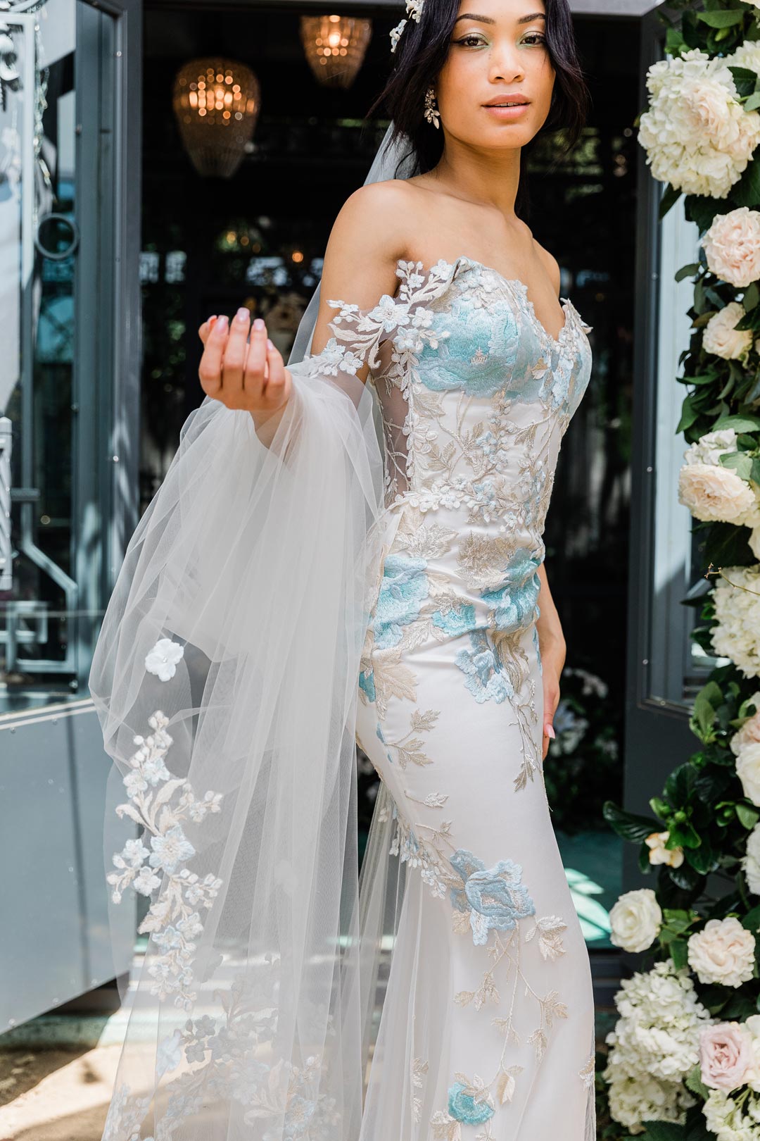Bride holding Wedding veil in Odessa Blue designed by Claire Pettibone