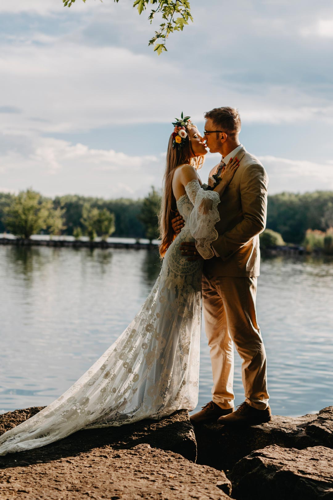Bride and Groom Kiss by lake Bride in Eloise Wedding Dress