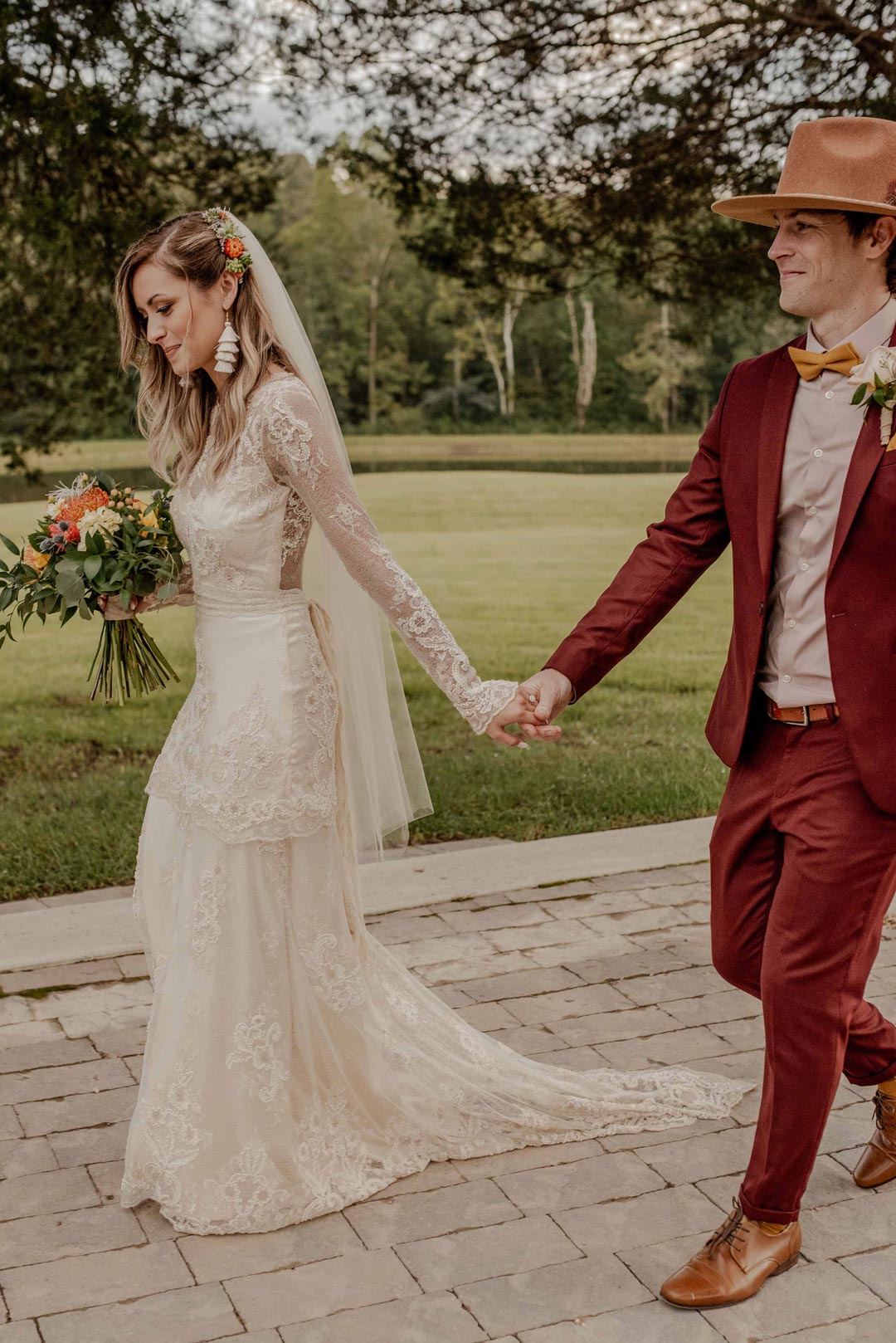 Bride and Groom Walking Holding Hands Bride wears Pearle by Claire Pettibone