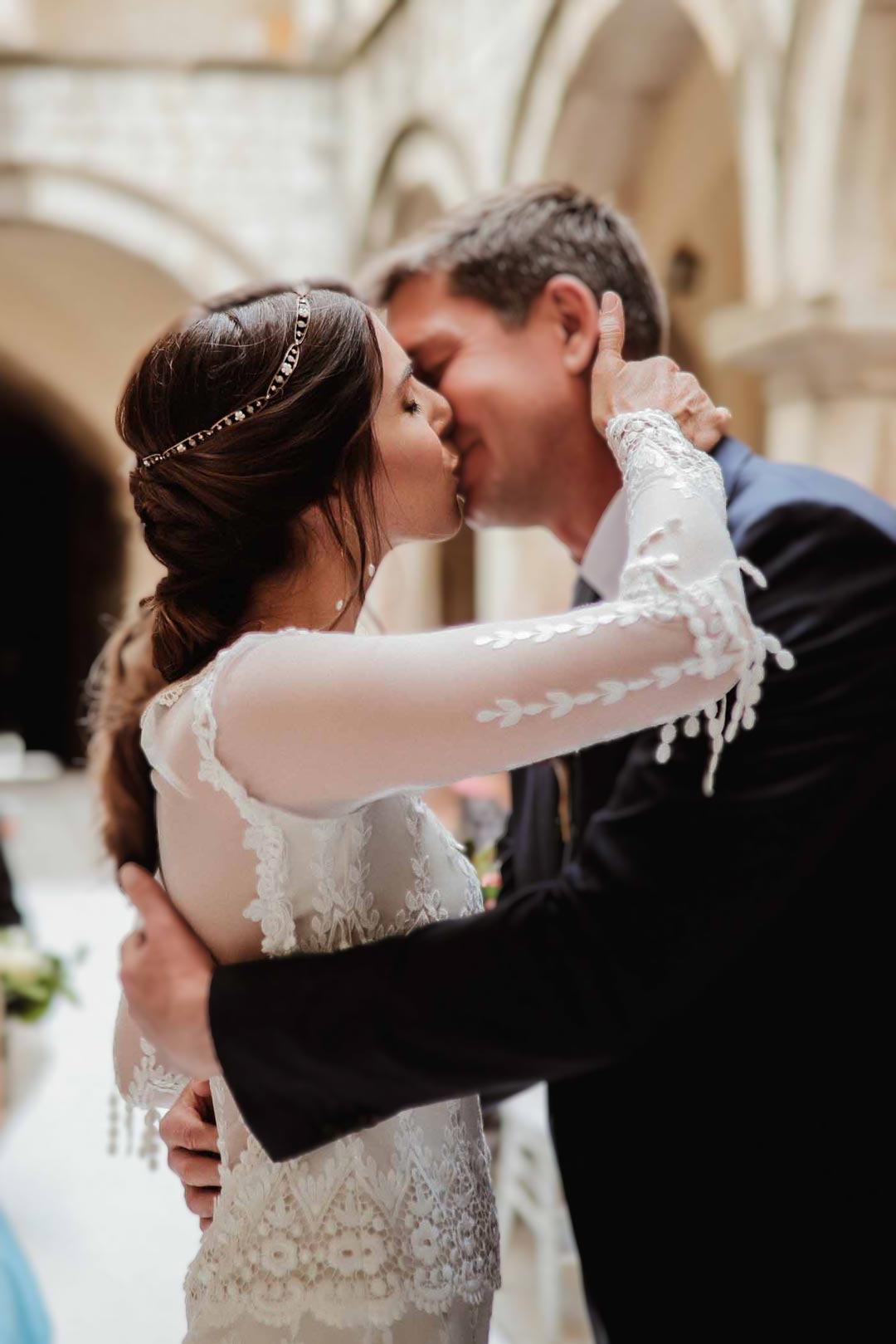 Bride and Groom Kiss at wedding ceremony bride in custom Long Sleeve Wedding Dress