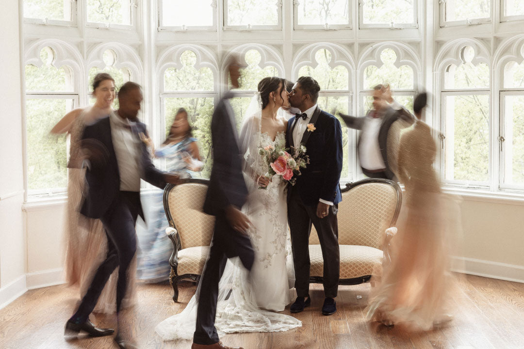 Bride and Groom Kiss as Guest Surround