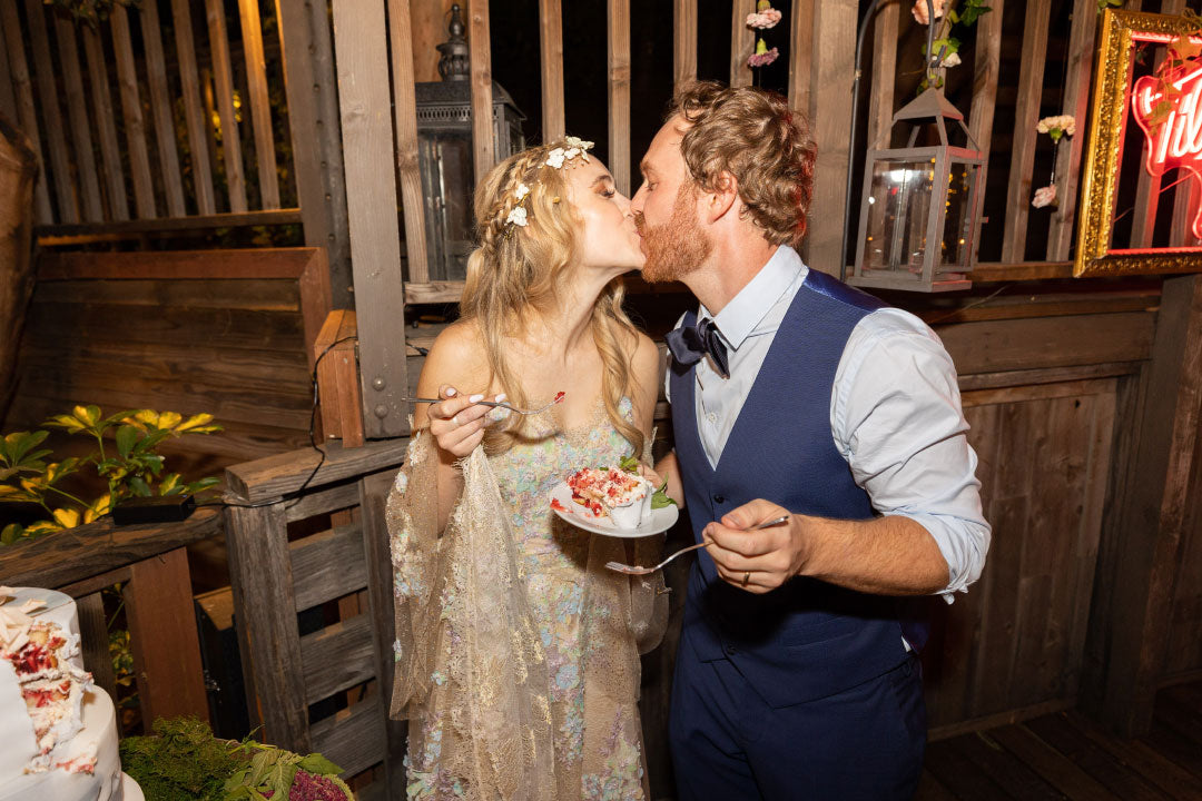 Bride and Groom Kissing holding wedding cake