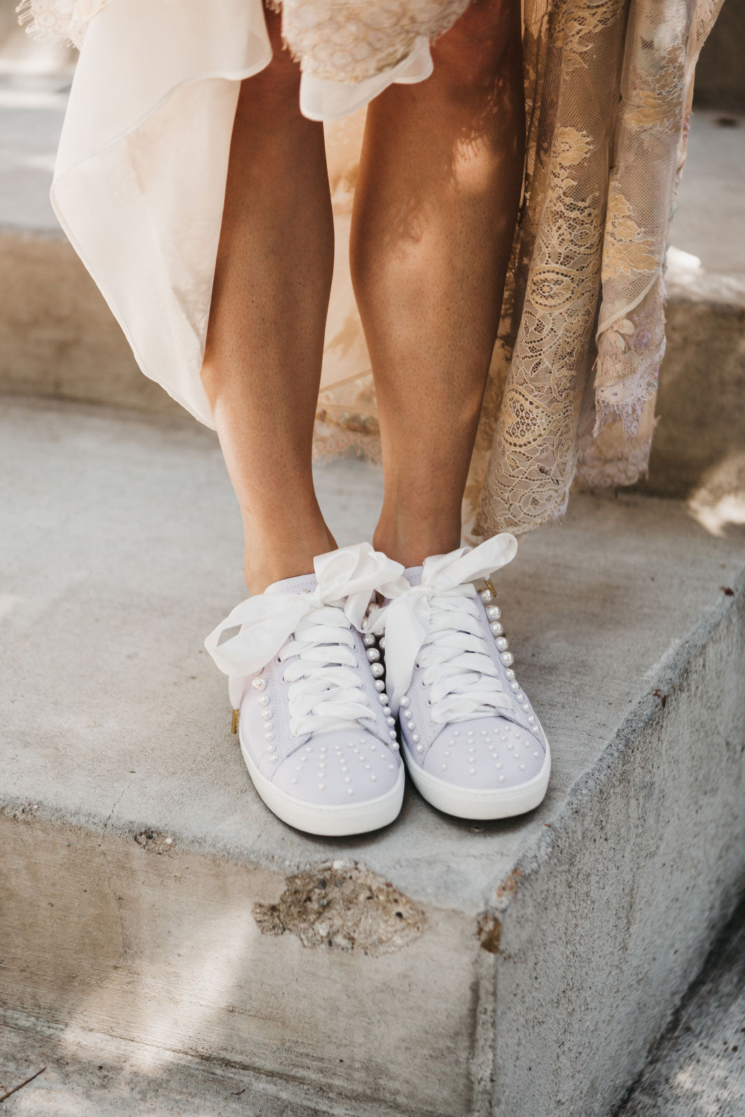 Bride wears pearl decorated tennis shoes