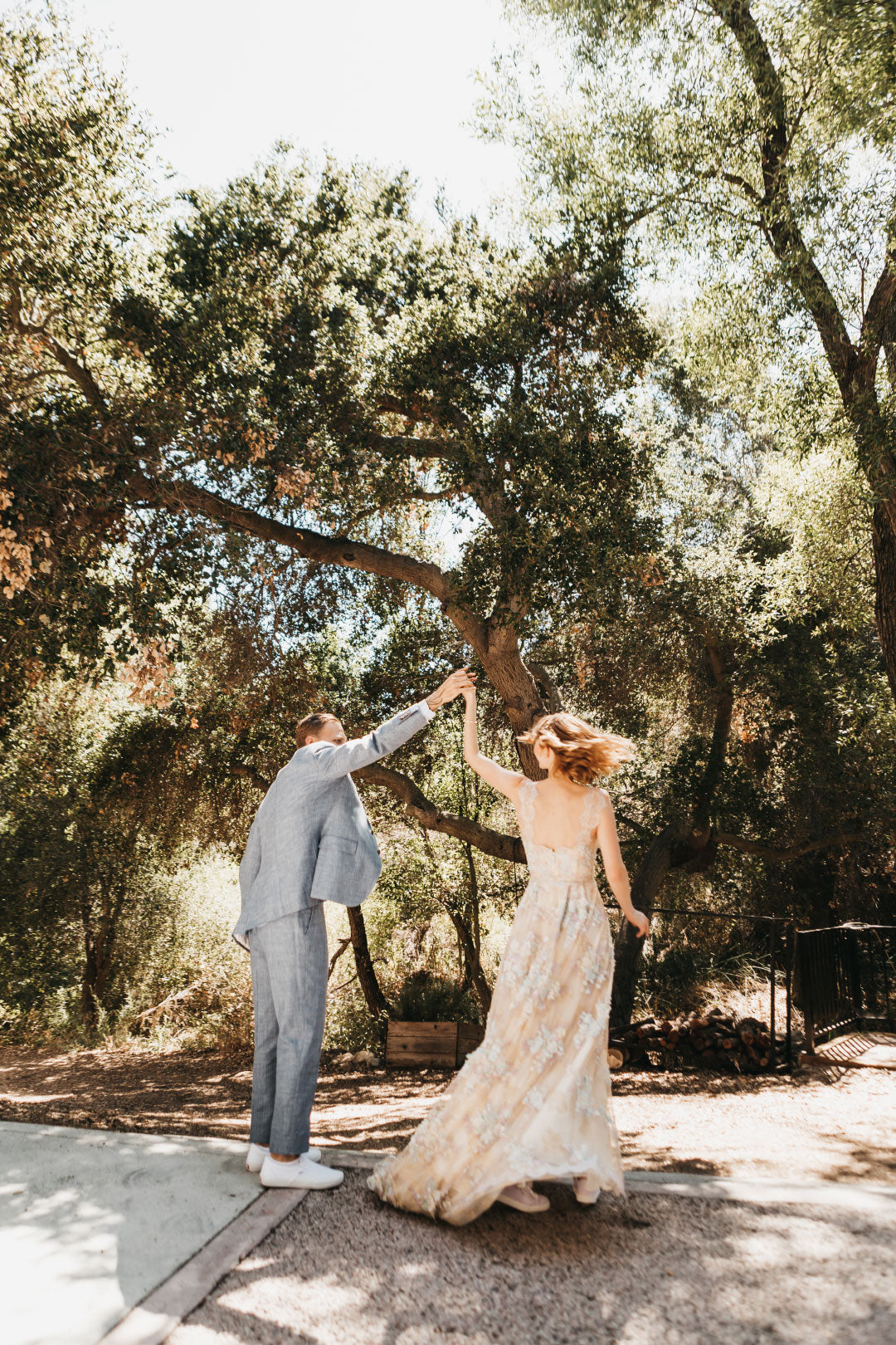 Groom twirls bride in wedding dress