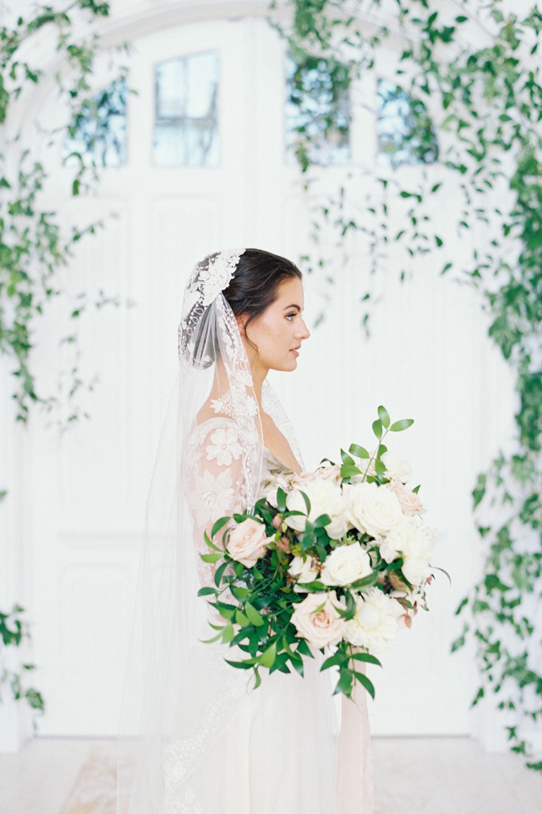 Profile of Bride in wedding veil holding wedding bouquet