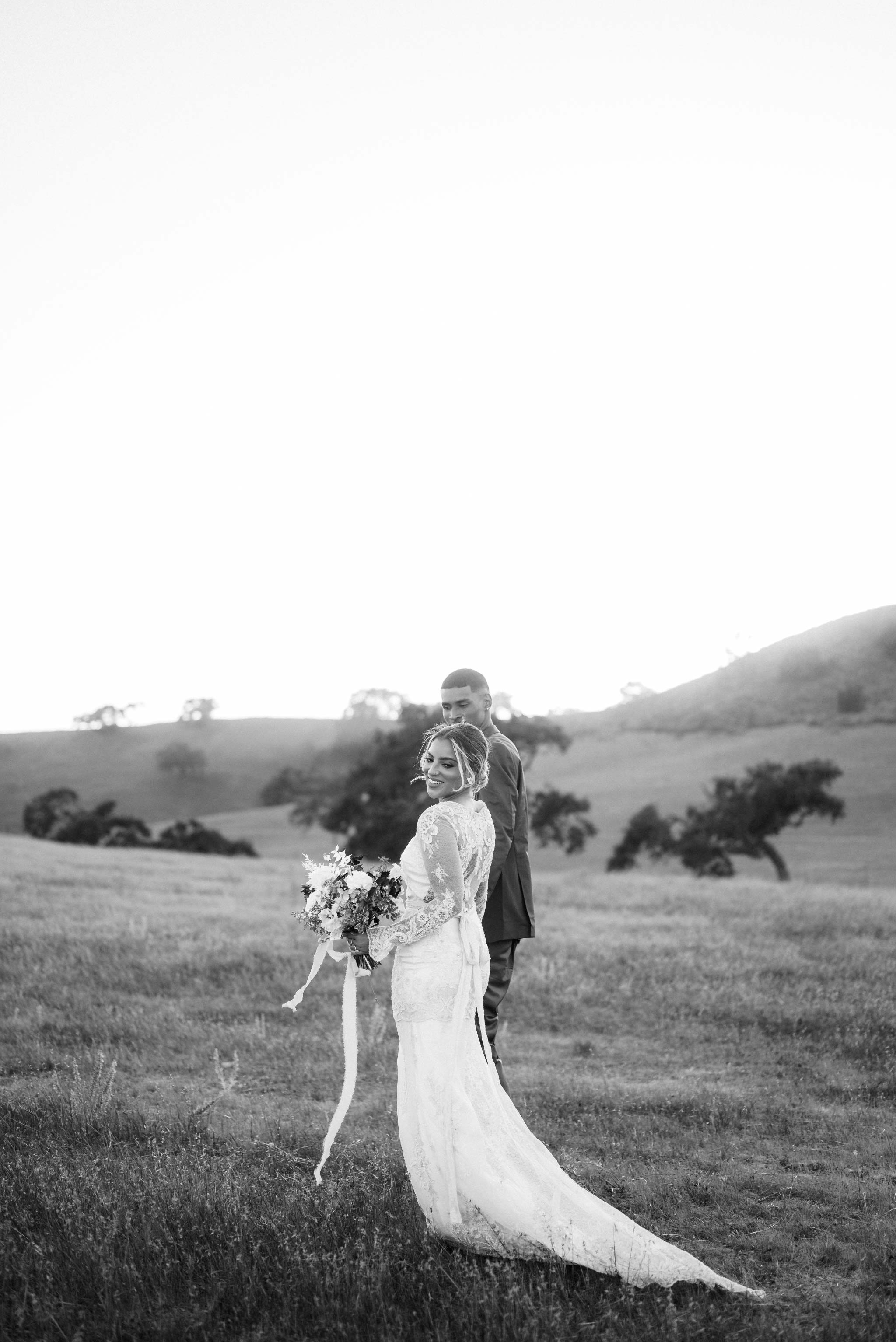 Bride and Groom at Kestrel Park Garden walking in open field