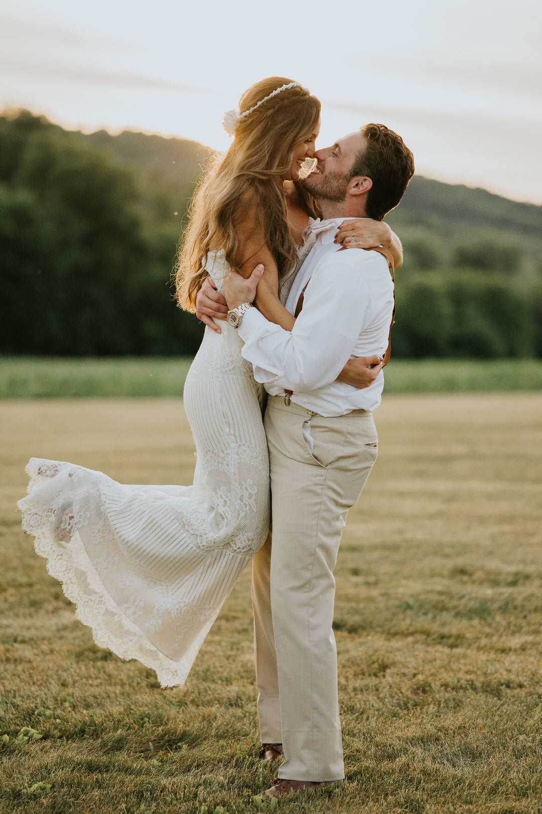 Bride lifted and embraced by Groom