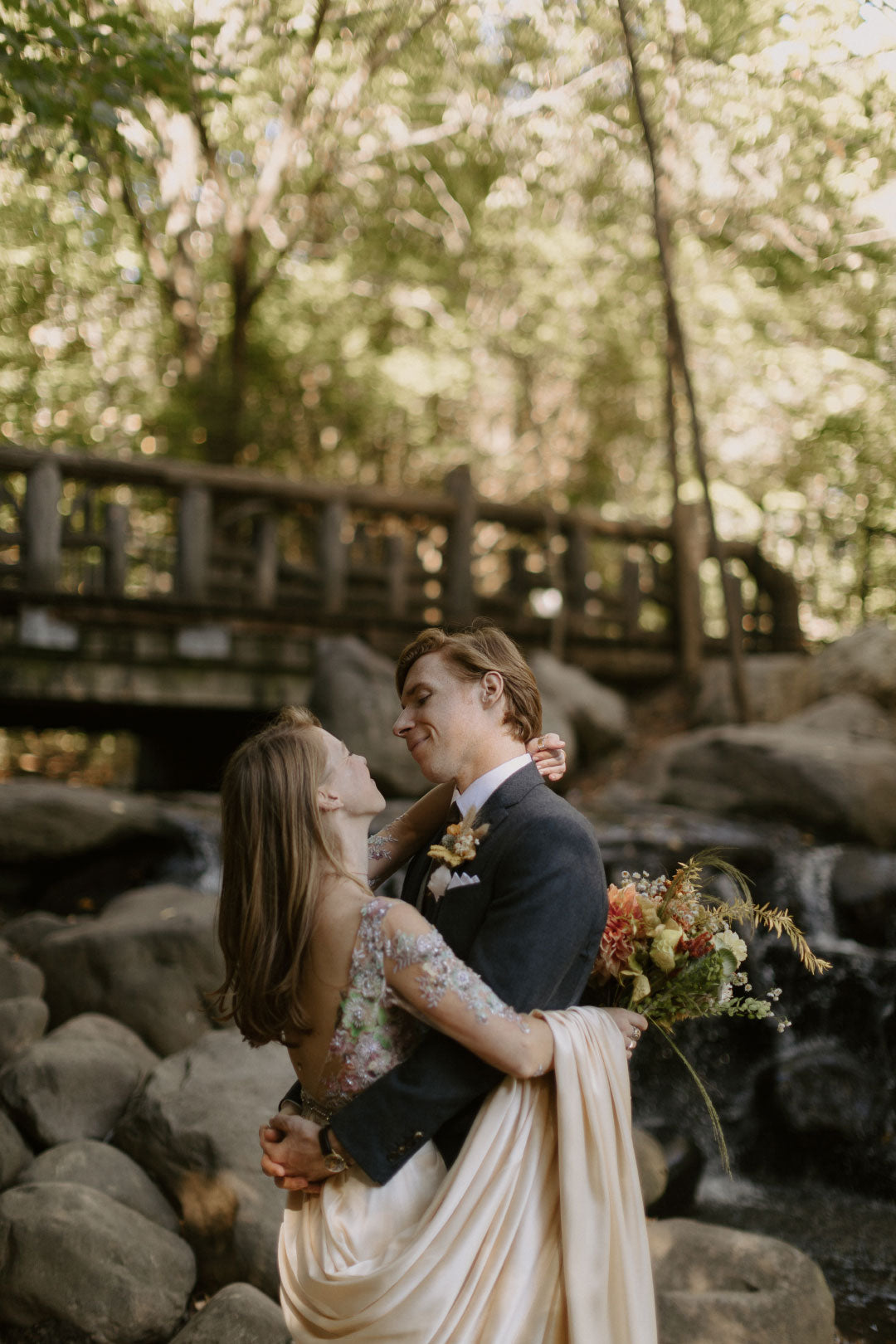 Bride and Groom embrace at park venue