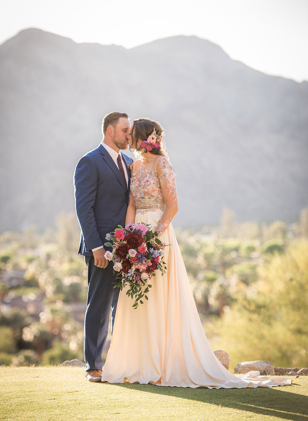 Bride and Groom on with desert in mountain in background