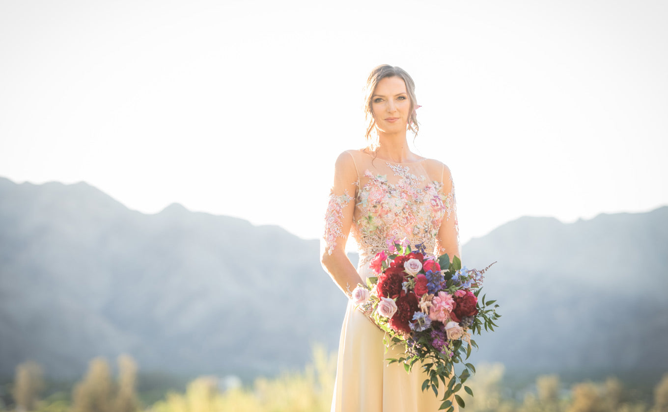 Bride wearing Santornia with desert mountains in background